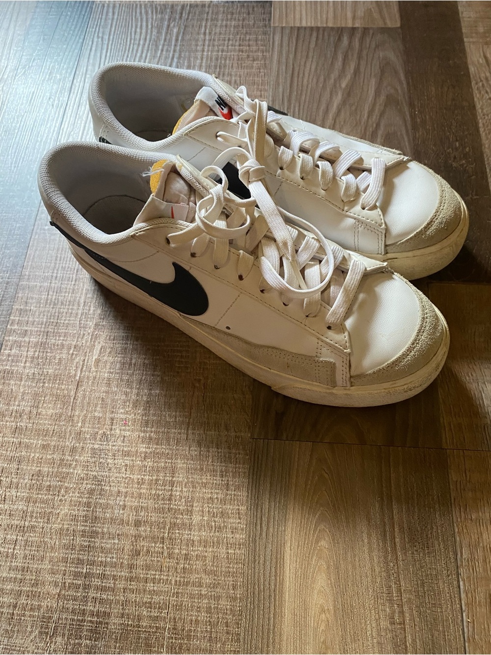 Nike White Low-Top Sneakers with Black Swoosh and Cream Accents